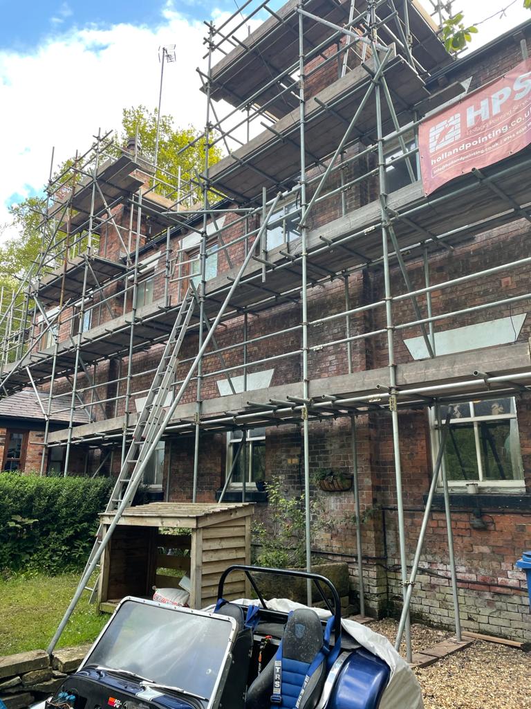 house with scaffolding being repointed